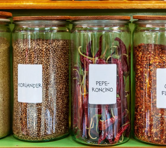 Different spices in jars placed in row