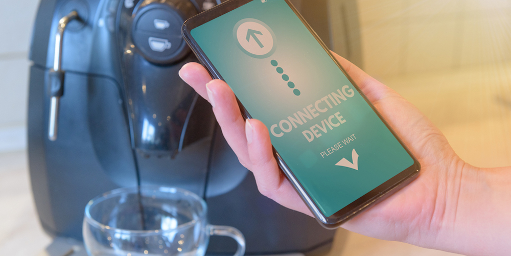 Connecting coffee machine with smart phone. Smart home and Internet of Things IoT concept