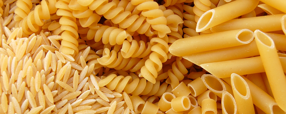 Four different kinds of pasta. Italian food background.
