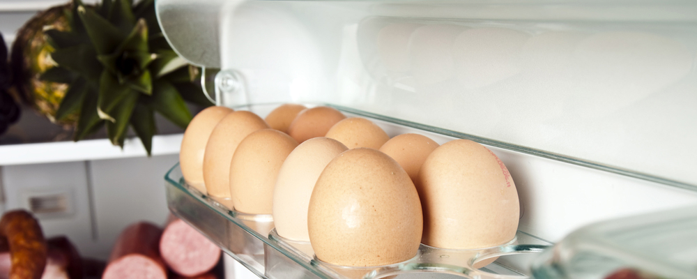 Refrigerator full of food close up to eggs