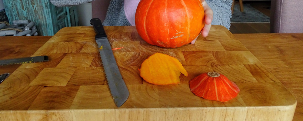 Slicing pumpkin on a wooden board