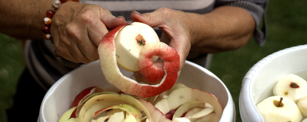 Person peeling apple