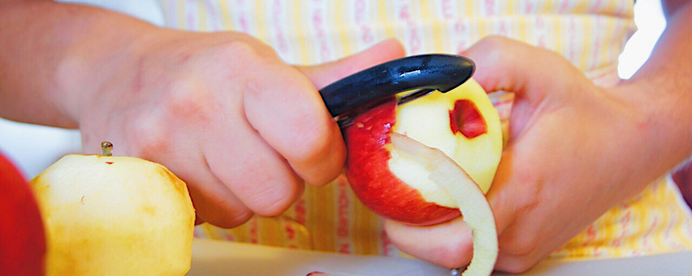 Woman peeling an apple